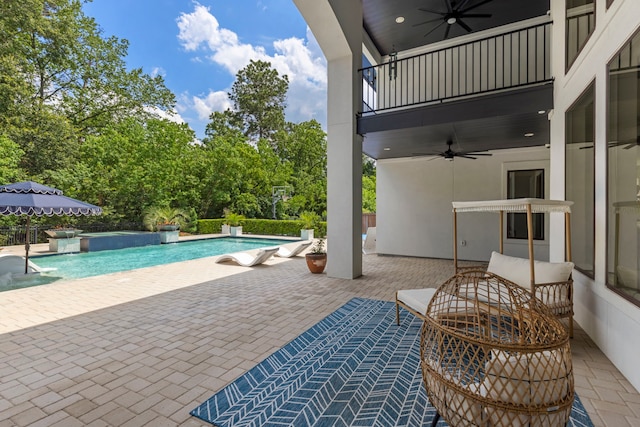8550 Tombron Grove Rd, Magnolia, TX 77354 - outdoor pool with ceiling fan, a patio area, and view of scattered trees