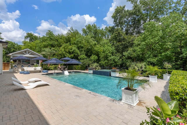 8550 Tombron Grove Rd, Magnolia, TX 77354 - outdoor pool with a patio area and an outdoor living space