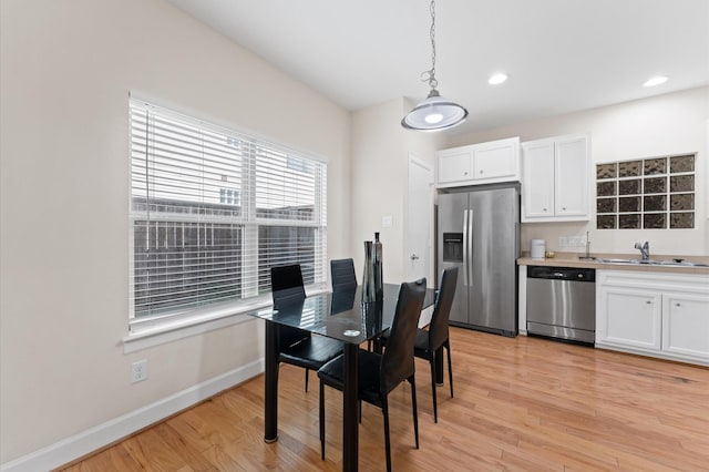 3736 Main Poplar Dr, Houston, TX 77025 - dining space with light wood-style floors and baseboards