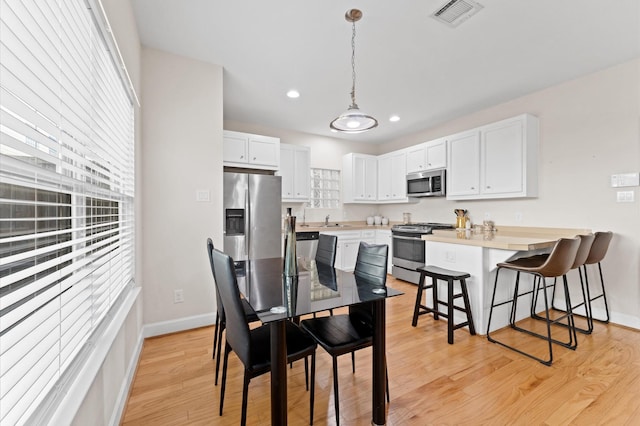 3736 Main Poplar Dr, Houston, TX 77025 - dining area featuring light wood-style floors and recessed lighting