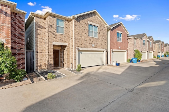 3736 Main Poplar Dr, Houston, TX 77025 - view of front of home featuring brick siding, concrete driveway, a garage, and a residential view