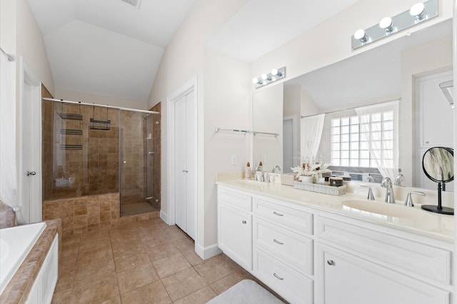 3736 Main Poplar Dr, Houston, TX 77025 - full bathroom with double vanity, a stall shower, lofted ceiling, tiled bath, and tile patterned flooring