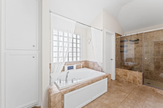 3736 Main Poplar Dr, Houston, TX 77025 - bathroom featuring a stall shower, a jetted tub, lofted ceiling, and tile patterned floors
