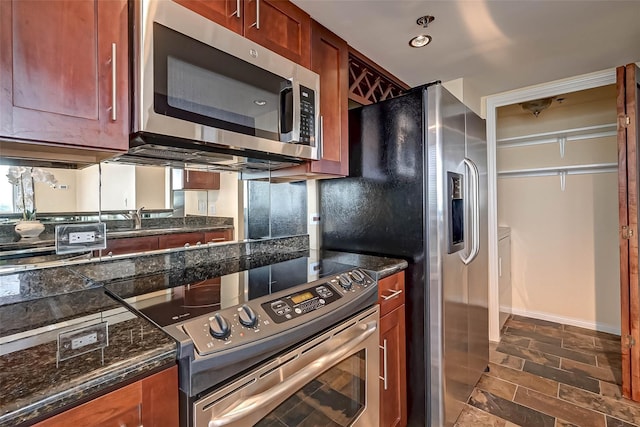3525 Sage Rd Unit 1703, Houston, TX 77056 - kitchen with appliances with stainless steel finishes, dark stone countertops, and dark stone finish flooring