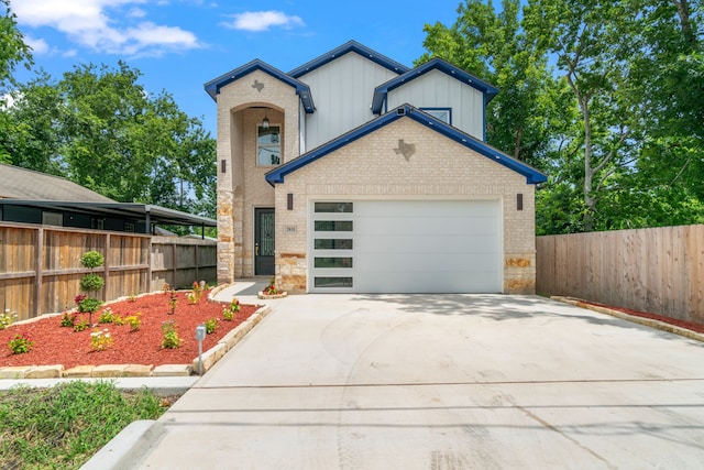 7831 Sandy St, Houston, TX 77028 - view of front of house with brick siding, board and batten siding, concrete driveway, and a garage