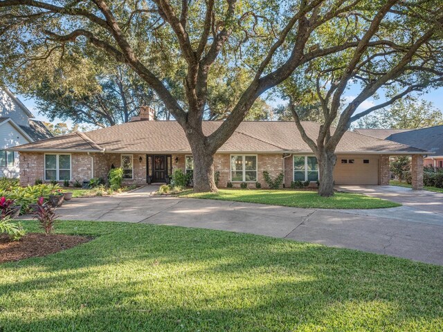 4710 Mckeever Ln, Missouri City, TX 77459 - single story home featuring brick siding, concrete driveway, a garage, and a chimney