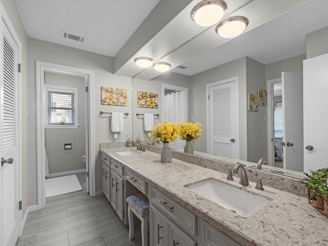4710 Mckeever Ln, Missouri City, TX 77459 - full bathroom featuring a closet, double vanity, and connected bathroom