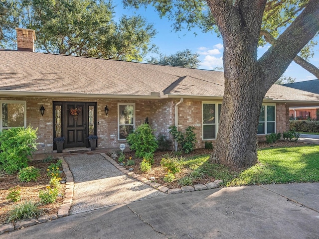 4710 Mckeever Ln, Missouri City, TX 77459 - single story home featuring brick siding, a chimney, a shingled roof, and covered porch