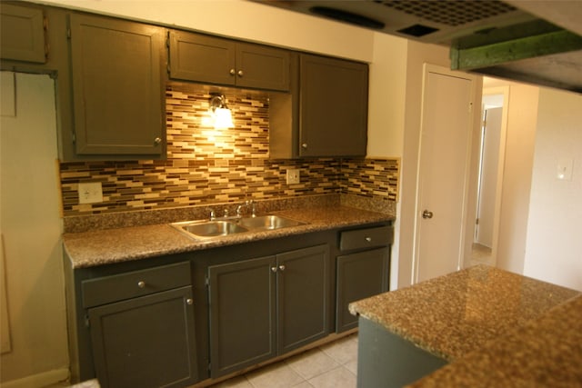 9711 Courben Ln, Houston, TX 77078 - kitchen featuring decorative backsplash, dark countertops, and light tile patterned floors