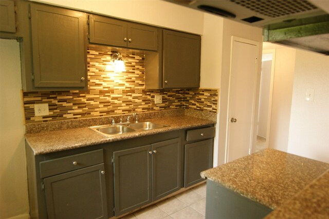 9711 Courben Ln, Houston, TX 77078 - kitchen featuring decorative backsplash and light tile patterned floors