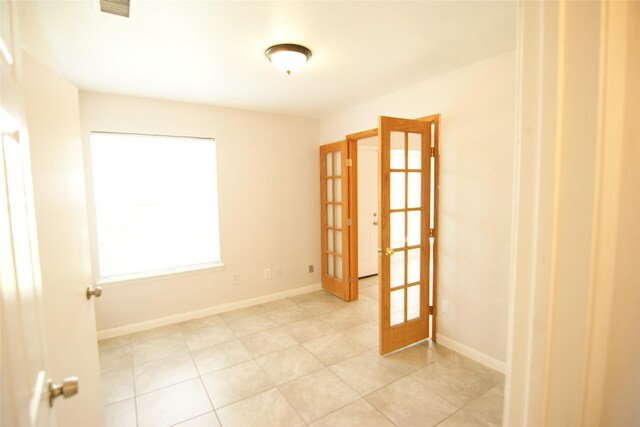 9711 Courben Ln, Houston, TX 77078 - spare room featuring french doors and light tile patterned floors