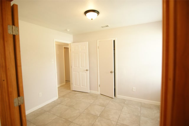 9711 Courben Ln, Houston, TX 77078 - unfurnished bedroom featuring light tile patterned floors and baseboards
