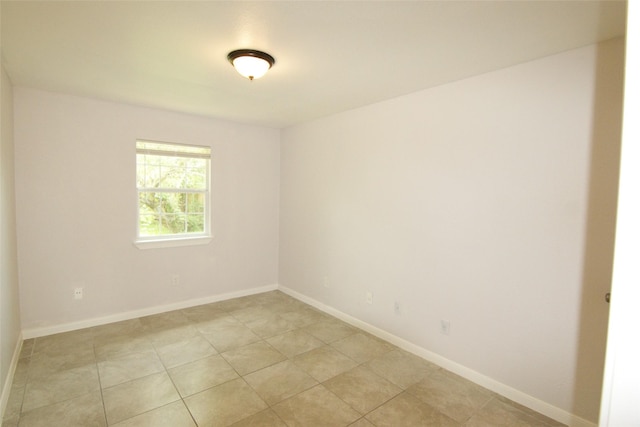 9711 Courben Ln, Houston, TX 77078 - unfurnished room with baseboards and light tile patterned flooring