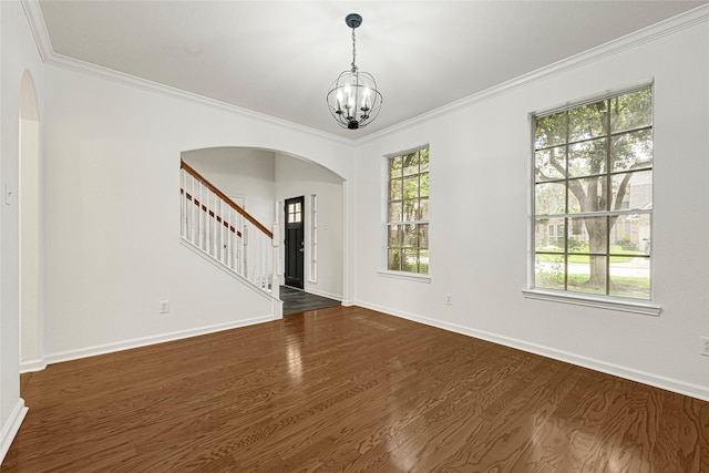 7823 Autumn Hollow Ln, Houston, TX 77041 - empty room featuring arched walkways, stairway, a chandelier, dark wood finished floors, and crown molding
