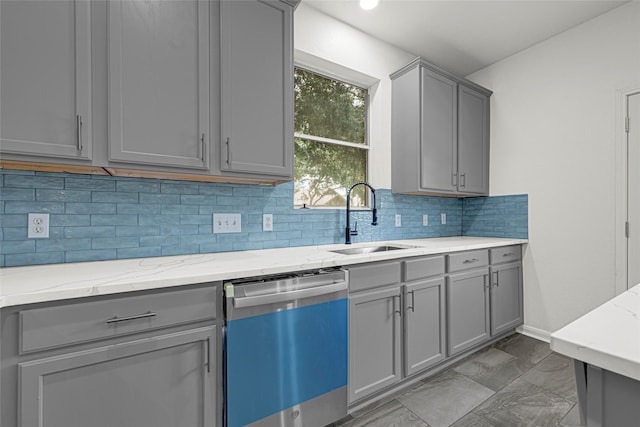 7823 Autumn Hollow Ln, Houston, TX 77041 - kitchen with dishwashing machine, gray cabinets, decorative backsplash, and light stone countertops