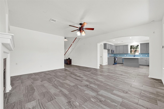 7823 Autumn Hollow Ln, Houston, TX 77041 - unfurnished living room featuring a ceiling fan, arched walkways, and recessed lighting