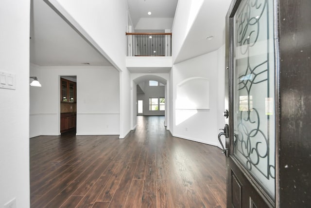 4330 Lasker Brook Ct, Katy, TX 77494 - foyer featuring dark wood-style flooring, a towering ceiling, arched walkways, and ornamental molding