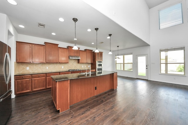 4330 Lasker Brook Ct, Katy, TX 77494 - kitchen featuring appliances with stainless steel finishes, brown cabinets, recessed lighting, and dark wood-style floors