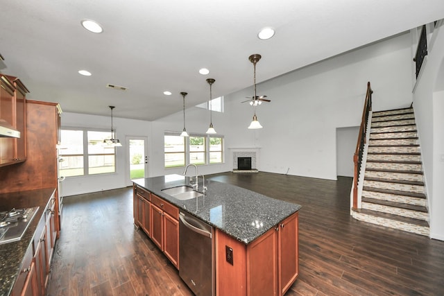 4330 Lasker Brook Ct, Katy, TX 77494 - kitchen featuring stainless steel appliances, ceiling fan, a fireplace with raised hearth, dark wood finished floors, and vaulted ceiling