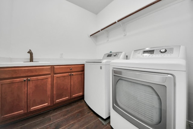 4330 Lasker Brook Ct, Katy, TX 77494 - washroom with washer and clothes dryer, dark wood-type flooring, and cabinet space
