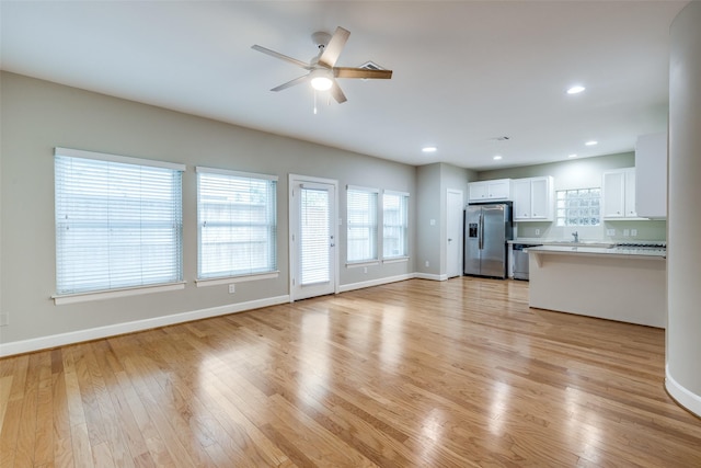 8765 Bryam, Houston, TX 77061 - unfurnished living room with ceiling fan, light wood-style flooring, healthy amount of natural light, and recessed lighting