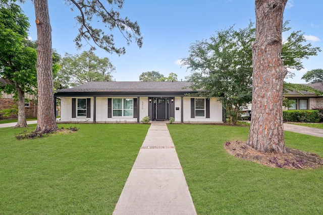5630 Lymbar Dr, Houston, TX 77096 - ranch-style house featuring brick siding, a front lawn, and roof with shingles