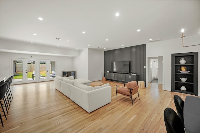 5630 Lymbar Dr, Houston, TX 77096 - living area with light wood-style flooring, ornamental molding, recessed lighting, built in features, and french doors