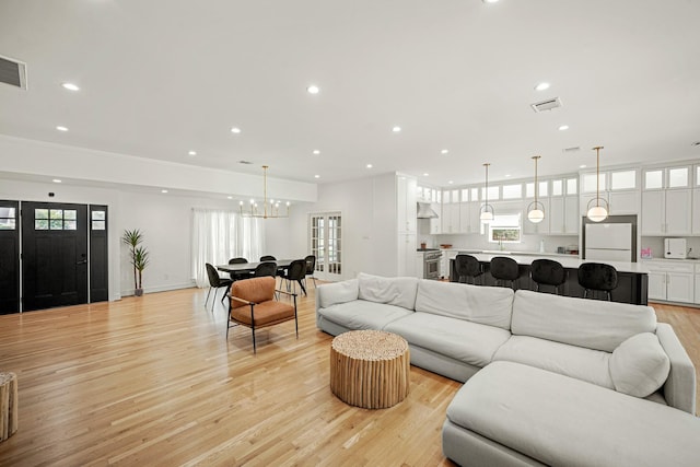 5630 Lymbar Dr, Houston, TX 77096 - living room with recessed lighting, a chandelier, light wood-type flooring, and plenty of natural light