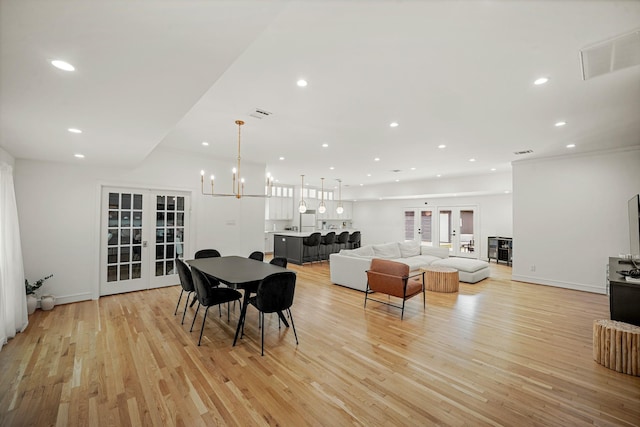 5630 Lymbar Dr, Houston, TX 77096 - dining room featuring french doors, light wood-style flooring, recessed lighting, and a chandelier