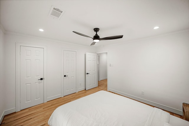 5630 Lymbar Dr, Houston, TX 77096 - bedroom featuring crown molding, light wood finished floors, a ceiling fan, multiple closets, and recessed lighting