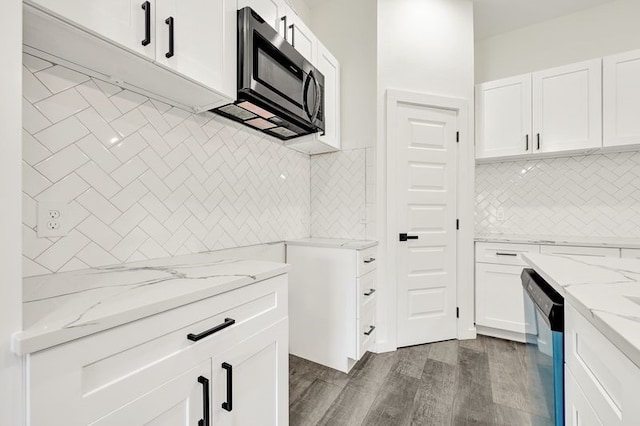 7922 Sealey St, Houston, TX 77088 - kitchen featuring stainless steel microwave, dishwashing machine, light stone countertops, dark wood-type flooring, and white cabinetry