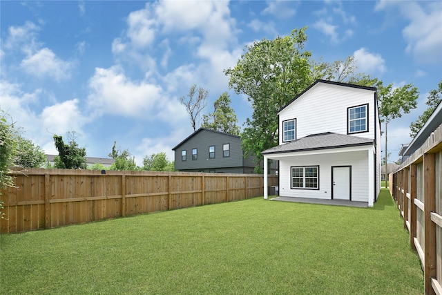 7922 Sealey St, Houston, TX 77088 - rear view of house with a fenced backyard, a patio area, and a shingled roof