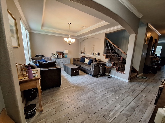 20331 Weeping Pine Way, Richmond, TX 77407 - living area with wood finished floors, arched walkways, stairs, a raised ceiling, and crown molding
