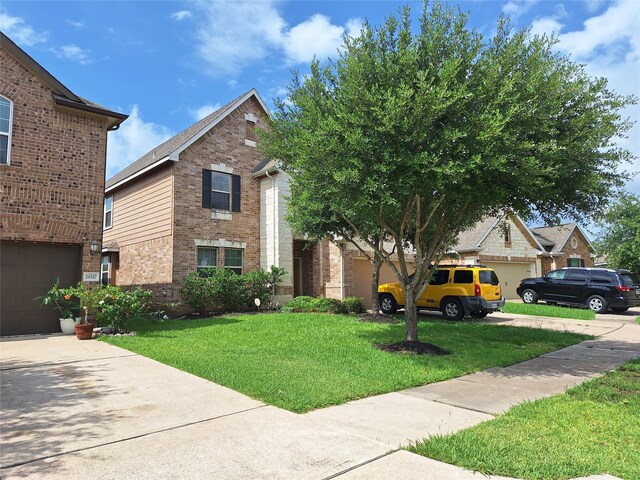 20331 Weeping Pine Way, Richmond, TX 77407 - view of front of house with brick siding, concrete driveway, a front lawn, and a garage