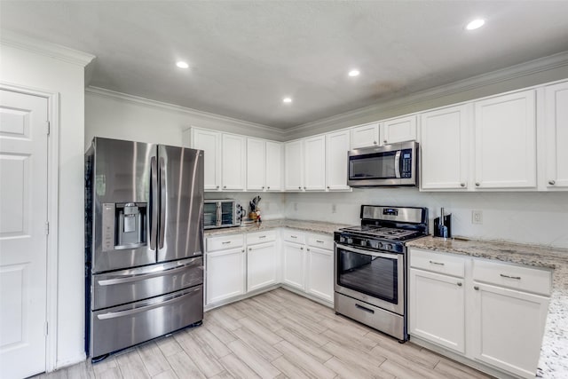 3038 Rainmont Ln, Katy, TX 77449 - kitchen with appliances with stainless steel finishes, crown molding, white cabinetry, light stone counters, and light wood-style floors
