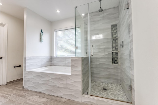 3038 Rainmont Ln, Katy, TX 77449 - bathroom with a garden tub, a stall shower, recessed lighting, and wood finished floors