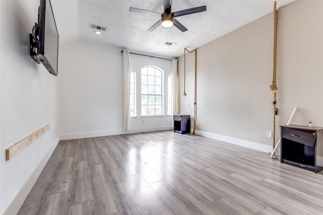 3038 Rainmont Ln, Katy, TX 77449 - unfurnished living room with a ceiling fan, wood finished floors, and a textured ceiling