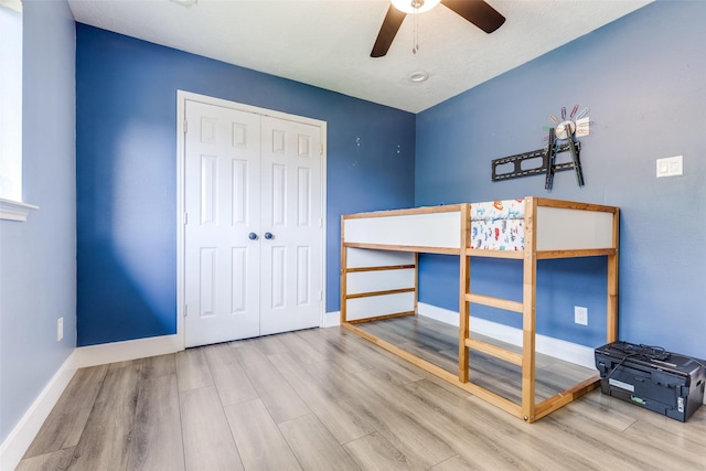 3038 Rainmont Ln, Katy, TX 77449 - bedroom with wood finished floors, a closet, and a ceiling fan