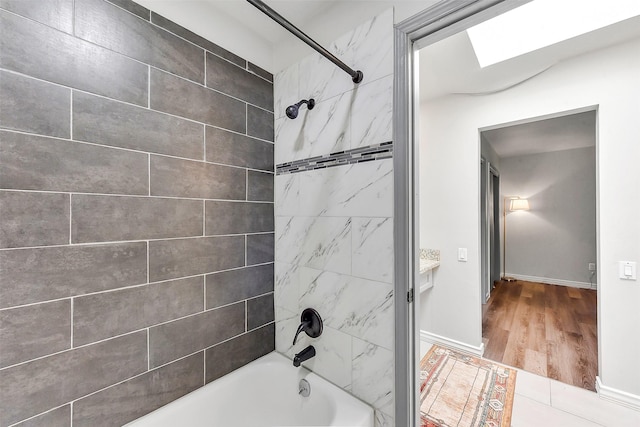 169 Litchfield Ln, Houston, TX 77024 - bathroom with shower / bathtub combination, wood finished floors, and a skylight