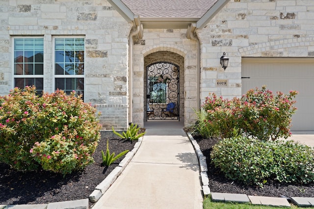 6919 Shoreline View Dr, Katy, TX 77493 - doorway to property with stone siding, roof with shingles, and an attached garage