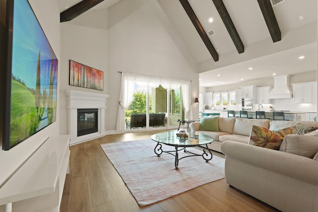 6919 Shoreline View Dr, Katy, TX 77493 - living room featuring beam ceiling, high vaulted ceiling, wood finished floors, recessed lighting, and a glass covered fireplace