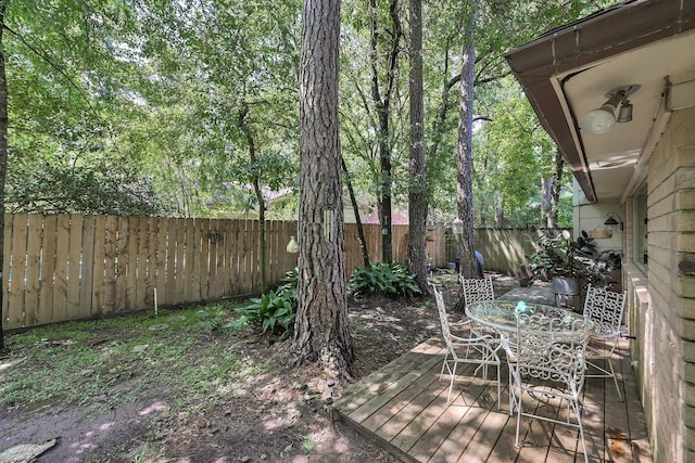 58 Sandpebble Dr, Spring, TX 77381 - wooden terrace with a fenced backyard and outdoor dining space