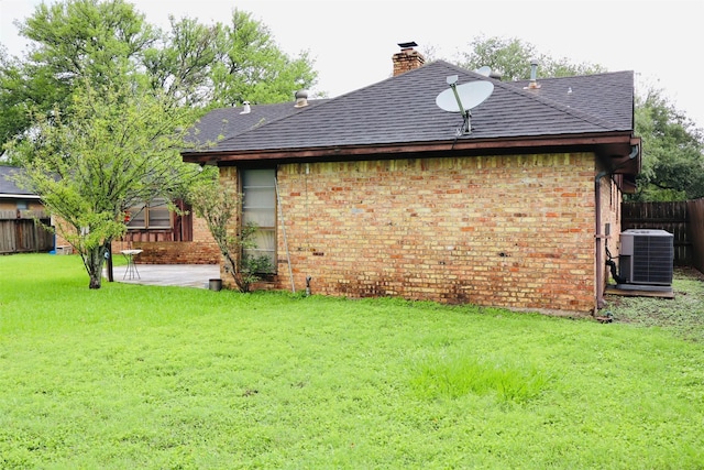 1108 Easy St, Rosenberg, TX 77471 - rear view of house with brick siding, a shingled roof, a chimney, and a patio