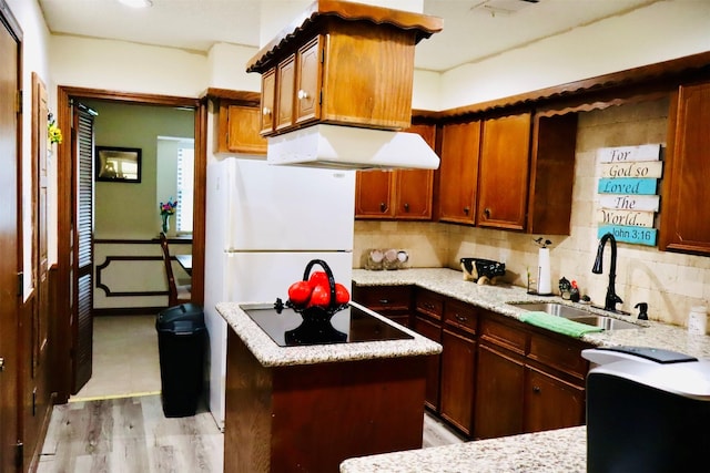 1108 Easy St, Rosenberg, TX 77471 - kitchen featuring freestanding refrigerator, black electric cooktop, range hood, tasteful backsplash, and a center island