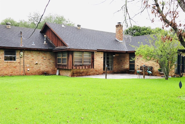 1108 Easy St, Rosenberg, TX 77471 - rear view of house with a chimney, a patio area, brick siding, and a yard