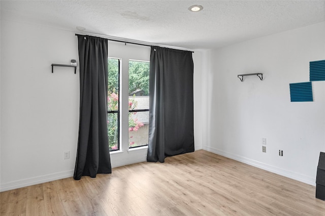 8033 Oakwood Forest Dr, Houston, TX 77040 - empty room featuring light wood-type flooring and a textured ceiling