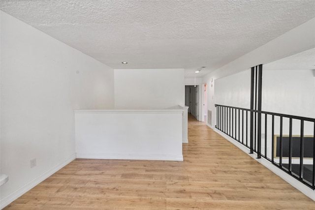 8033 Oakwood Forest Dr, Houston, TX 77040 - spare room with light wood finished floors and a textured ceiling