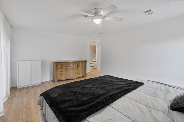 8033 Oakwood Forest Dr, Houston, TX 77040 - bedroom with wood finished floors and a ceiling fan