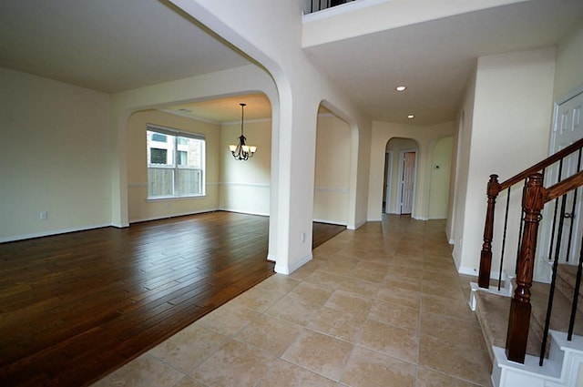 4202 Misty Waters Ln, Katy, TX 77494 - entrance foyer with arched walkways, a chandelier, recessed lighting, stairs, and light wood-style floors