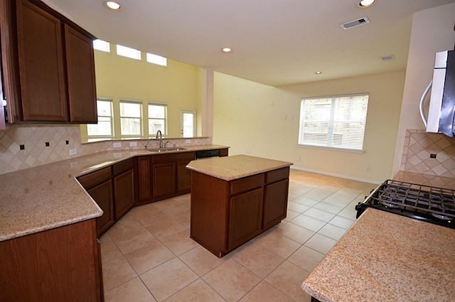 4202 Misty Waters Ln, Katy, TX 77494 - kitchen with black appliances, decorative backsplash, light tile patterned floors, recessed lighting, and a center island